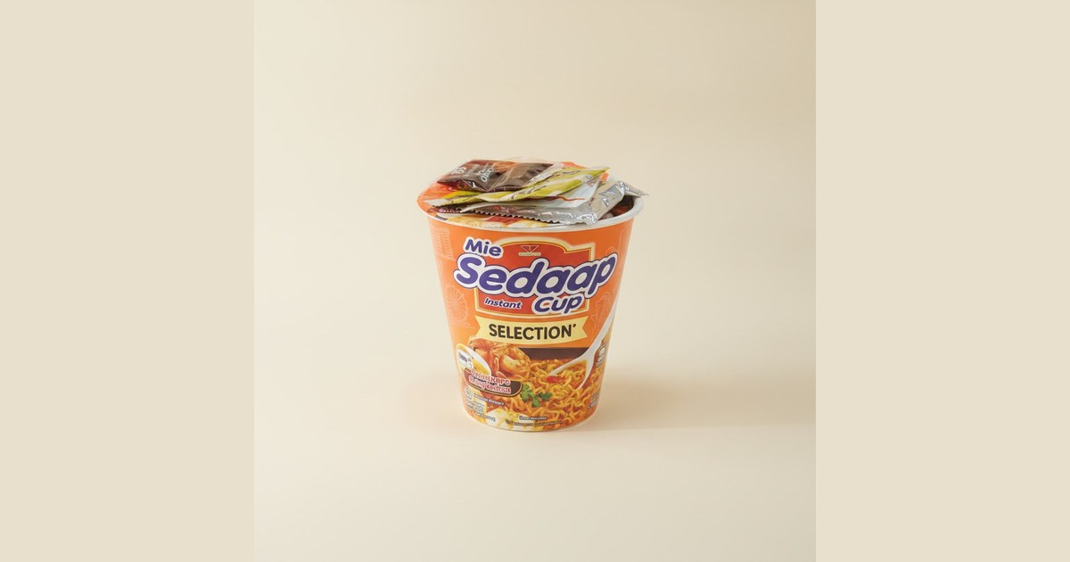 Instant noodles in a cup with seasoning packets.